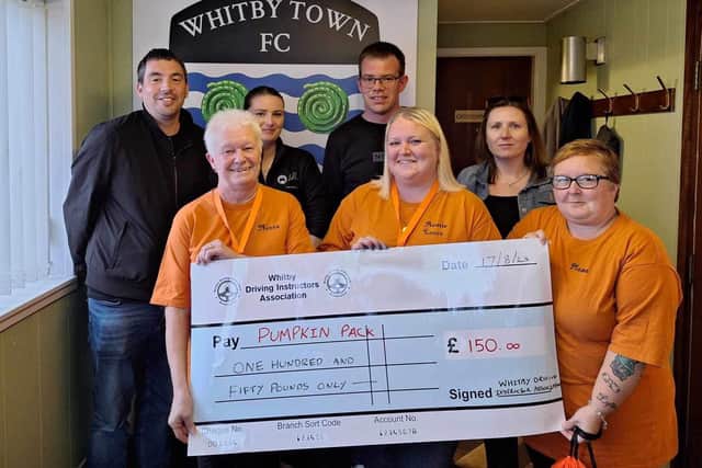 Whitby Driving Instructors Association present a cheque for £150 to Pumpkin Parent Packs representatives.