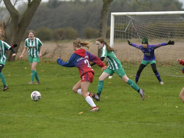 Scarborough Ladies FC Under-15s' Ruby Carney races to beat Wigginton to the ball