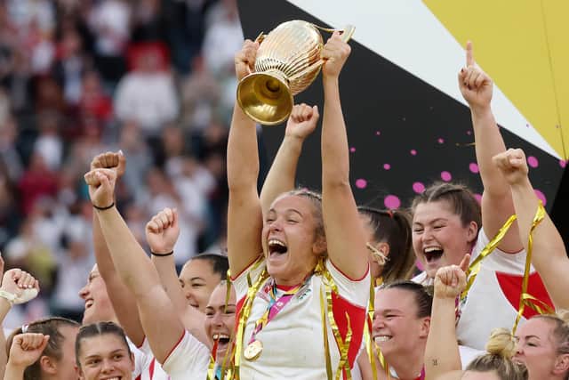 Zoe Stratford (nee Aldcroft) of England lifts the Women's Rugby World Cup trophy. Photo by David Rogers/Getty Images)