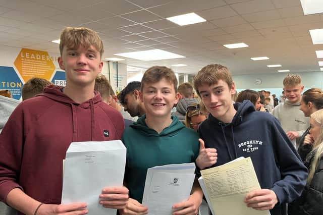Henry, Max and Michael celebrate their results