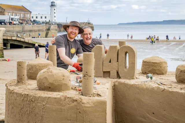 Jamie Wardley and Peter McKenna from Sand in Your Eye create a sand sculpture to mark the 140th birthday of Scarborough firm Cooplands Bakery. Photo courtesy of Marisa Cashill.