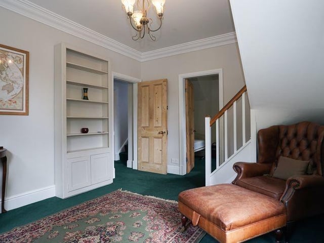 A spacious hallway with staircase leading up.