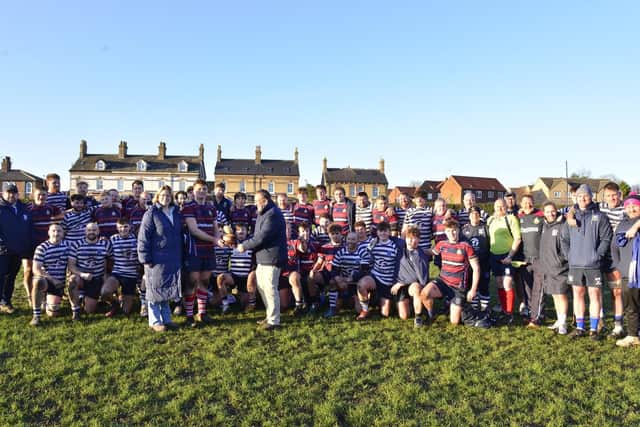 Pocklington School head Becky Lovelock and Pocklington RUFC President Paul Rhodes present the Bottomley Trophy to winning Old Pocklingtonian skipper James Flint.  Photo by Andy Nelson