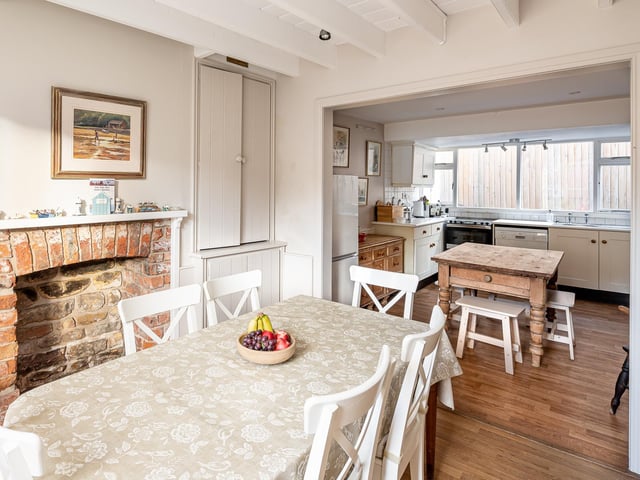 The cottage kitchen opens through to the dining room.