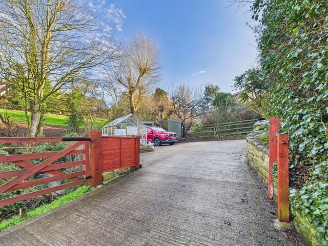 Driveway and parking area. The property also has a garage.