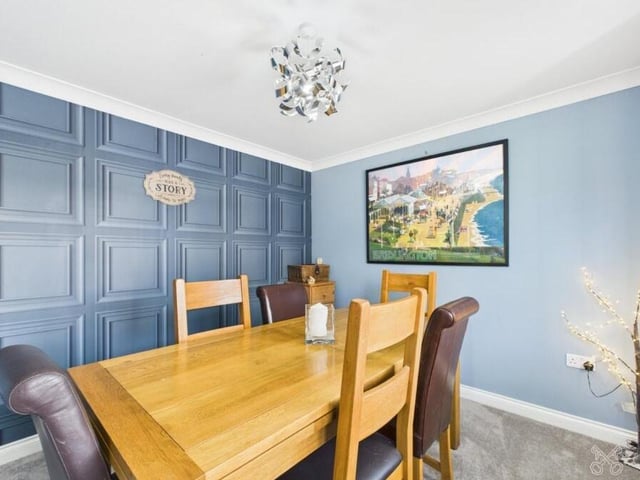 The dining room has a panelled wall.