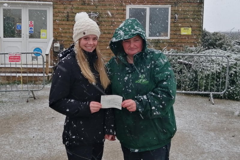 Graduate Olivia Coates hands Whitby Wildlife Sanctuary a cheque for £500.