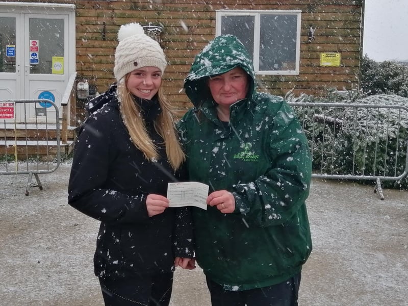 Graduate Olivia Coates hands Whitby Wildlife Sanctuary a cheque for £500.