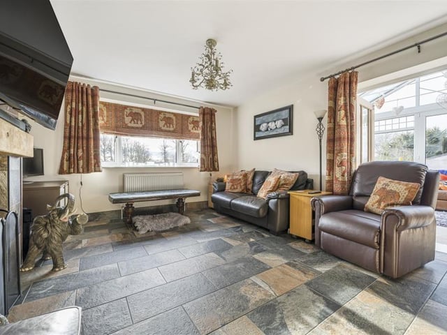 The fireplace with stove is a focal point of this room, with the conservatory to the rear.