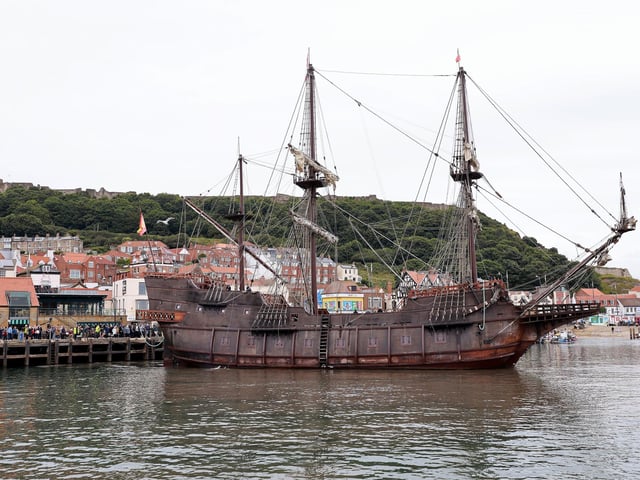 The galleon with the castle walls in the background