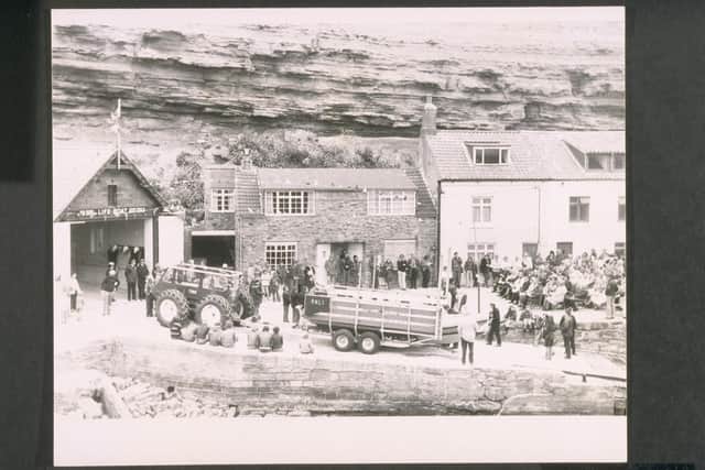 Staithes and Runswick. Atlantic 21 Class. ON B-538. Lord Bortherton. Re-opening of Staithes lifeboat station renamed Staithes and Runswick and naming ceremony of the Atlantic 21 class lifeboat on trailer with tractor, crowds watching ceremony, houses in background. Image: RNLI
