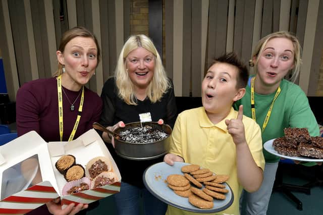 Cakes galore at the coffee morning...volunteers Anna Blower, Kathryn Benson, Mel Isacc and a pupil ready to serve cakes!