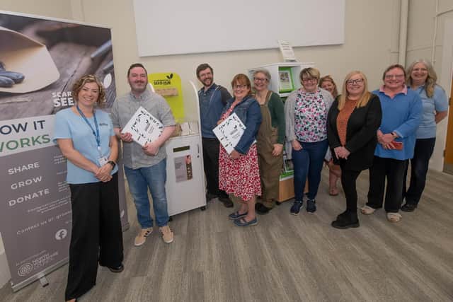 Darren Mancrief and Cllr Liz Colling (holding the information folders) surrounded by library staff, GROW Scarborough volunteers and library visitors.