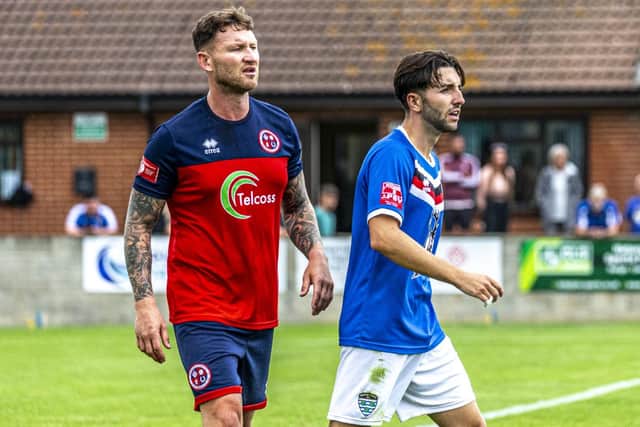 Former Blues defender Kev Burgess and Layton Watts. Photo by Brian Murfield