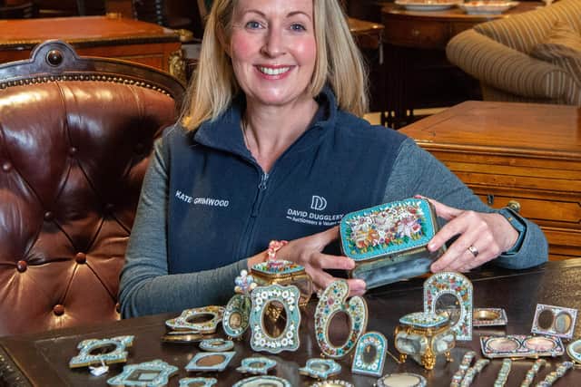 Kate Grimwood with some of the dozens of pieces found in one cardboard box. Photo: David Duggleby