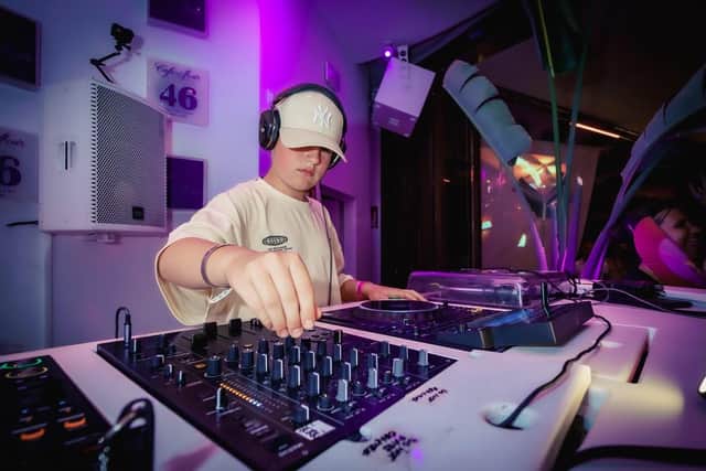 Alfie in control of the decks. Photo © Anna Alarie