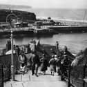 Visitors climb the 199 steps at Whitby in Yorkshire to get a better view of the town in the summer of 1931.