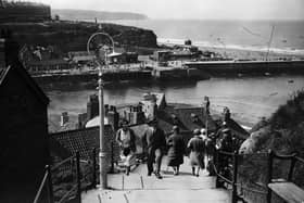 Visitors climb the 199 steps at Whitby in Yorkshire to get a better view of the town in the summer of 1931.