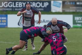 Scarborough's Jake Lyon is halted by two Moortown players.