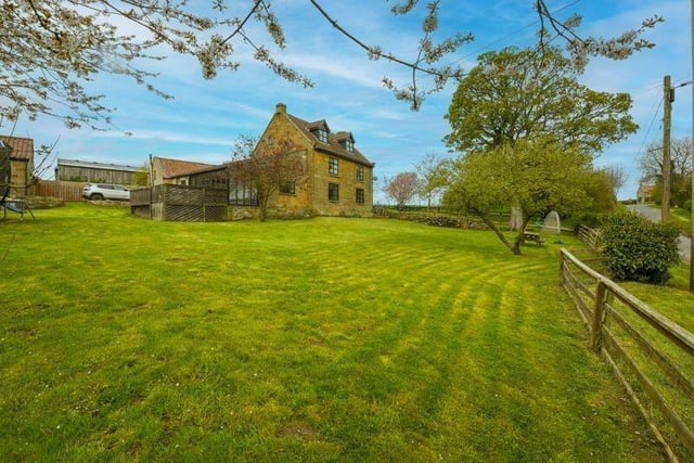 Extensive lawned gardens come with the hamlet home.