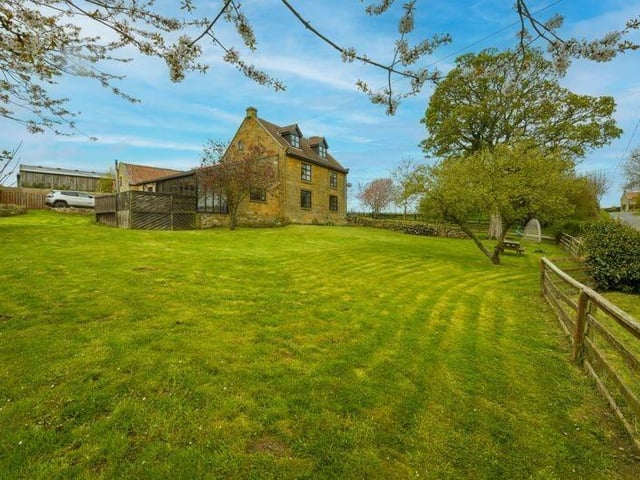 Extensive lawned gardens come with the hamlet home.