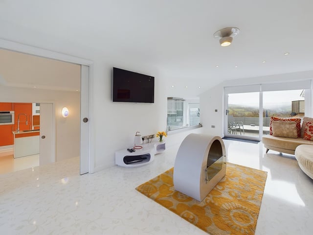 A spacious lounge has glazed doors to a sun terrace.