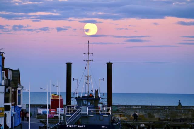 The Gypsey Race dredger frames the Harvest Moon, by Aled Jones.