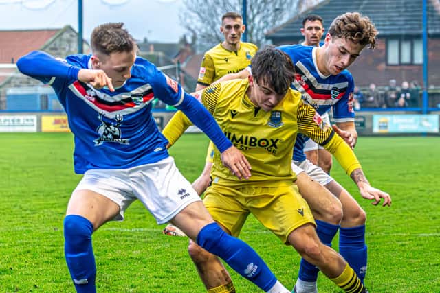 Whitby's Aaron Haswell (left) and Coleby Shepherd get stuck in against Bamber Bridge.