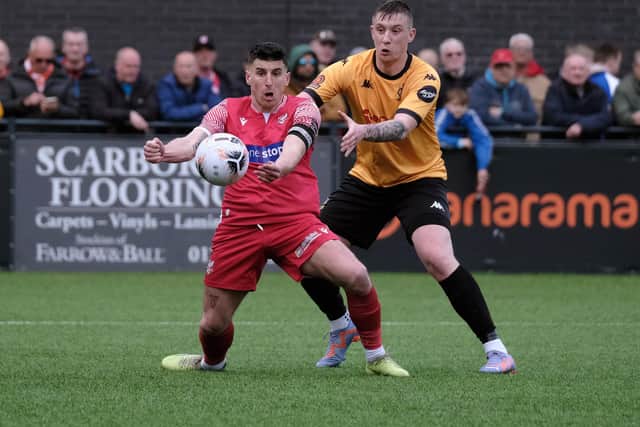 Skipper Michael Coulson holds the ball up for the home side.
