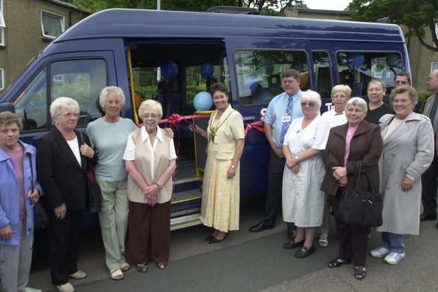 Scraithwood Drive, Parson Cross, Sheffield, where the Lord Mayor launched three mini buses  bought for use by local community groups in 2003. Seen is the Lord mayor as she cuts the tape to open the buses watched by locals.