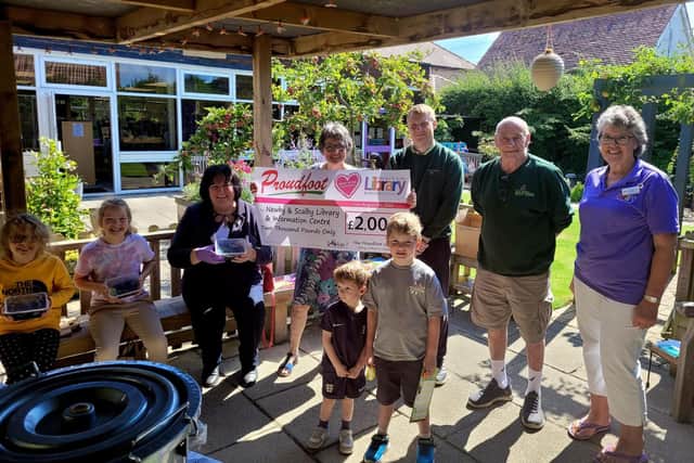 Proudfoot Supermarket Director Valerie Aston handing over the £2000 cheque.