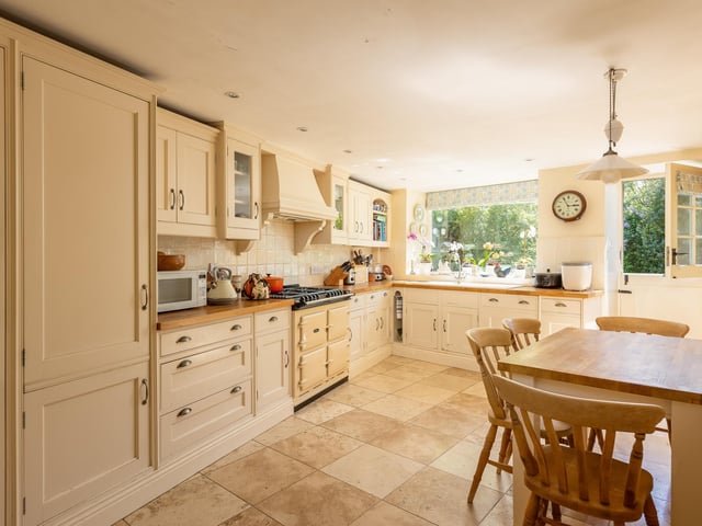 A farmhouse style kitchen with a range of integrated appliances.