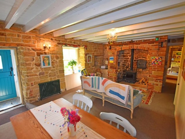 The characterful living room has a lovely inglenook fireplace as a central feature.