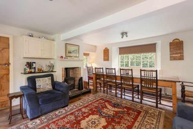 The living and dining area has a feature fireplace with warming stove.