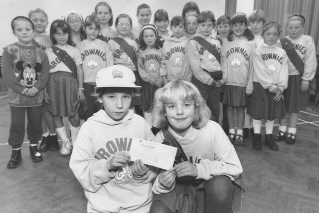 In November 1995, Brownies Becky Shone, left, and Samantha Wilton, are pictured with the cheque for £53.50 which was raised for the RSPCA. Looking on are the other Brownies who helped with the fundraising.   