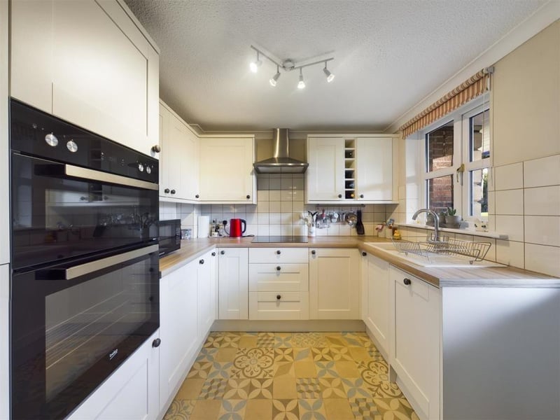 The kitchen has a fitted range of units, with an electric oven and hob, and an integrated dishwasher, fridge and freezer. There's a composite door to the communal gardens.