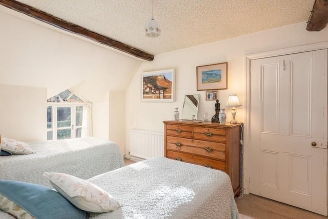 A charming twin bedroom within the property.