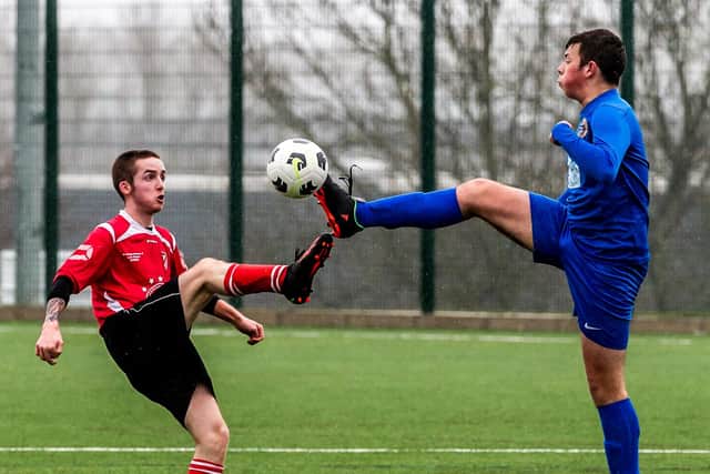Filey Town Reserves, red kit, challenge for the ball against Academy.