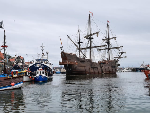 The galleon dwarfs other ships in the harbour