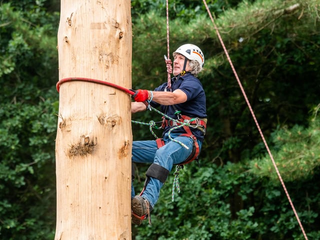 Andy Kirkwood (aged 61) taking part in the Pole Climbing Championships on the second day of the show