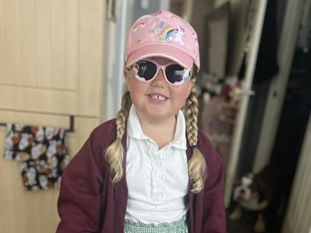 This little girl is all prepped for the sunshine, with her fantastic pink cap and shades on.
