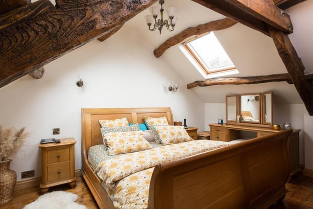 Another charming bedroom with exposed beams to the ceiling.