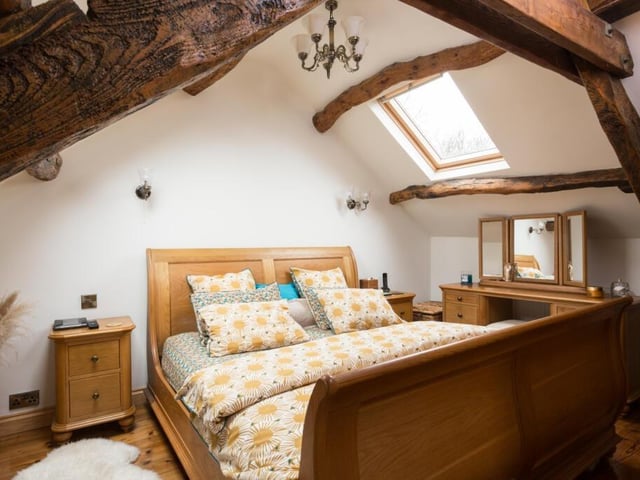 Another charming bedroom with exposed beams to the ceiling.