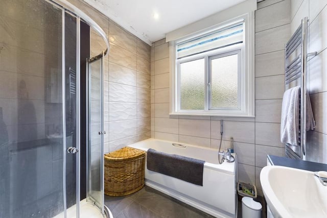 A stylish family bathroom with curved shower cubicle.