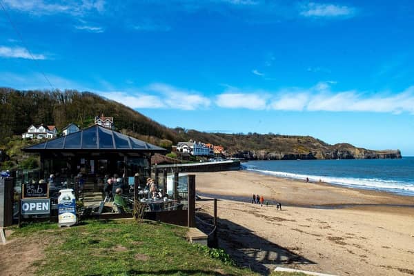 Walkers on the beach at Sandsend make the most of the good weather. (Pic credit: Bruce Rollinson)