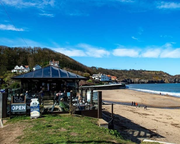 Walkers on the beach at Sandsend make the most of the good weather. (Pic credit: Bruce Rollinson)