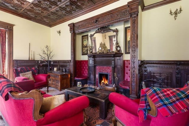Decorative carving to the fireplace, panelled walls and ceiling mark out this reception room.