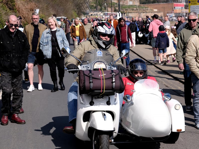A scooter and side car arriving on seafront!