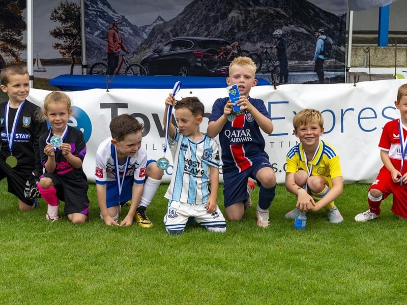 Young footballers with their medals.