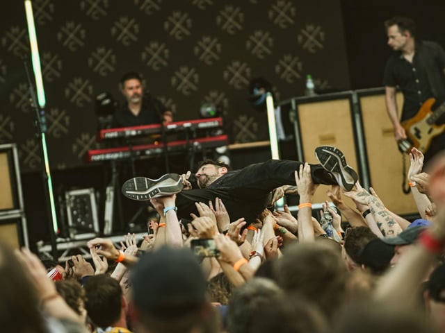 Frank Turner crowd surfs.